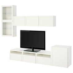 a flat screen tv sitting on top of a white entertainment center