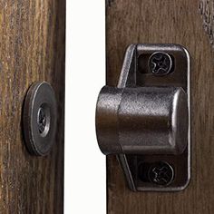 a close up of a door handle on a wooden door