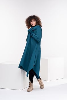 "Wool Cape, Knit Cardigan, Cloak with Hood This asymmetrical and modern cloak with hood has two side pockets, super comfy hood and thumb holes for a fabulous look. The model in the picture is 176cm. ⅼ 5.8 ft. tall and is wearing size S / color: Teal 🌟 INFO: * Worldwide EXPRESS shipping - please provide a phone number for shipping documents * US Sizing XS to 4XL - body size chart available below * We offer customization to Personal Measurements & Larger Sizes 5XL, 6XL, 7XL .... 🌟 MATERIAL & Oversized Knit Winter Cape, Black Hooded Cape, Gothic Hooded Winter Cape, Blue Hooded Winter Cape, Long Knitted Cardigan, Hooded Cape Purple, Cloak With Hood, Winter Cloak, Shipping Documents