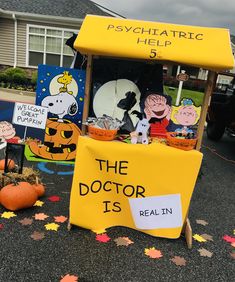 the doctor is real in sign with pumpkins and other decorations on the ground next to it