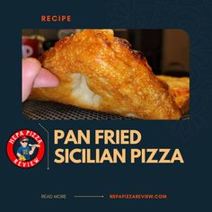 a person holding up a piece of pizza with the words pan fried sicilian pizza on it