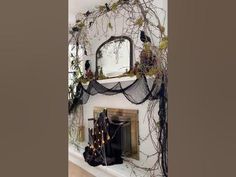 there is a fireplace decorated for halloween with vines on the mantle and decorations around it