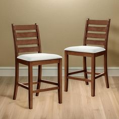 two wooden chairs sitting side by side on a hard wood floor