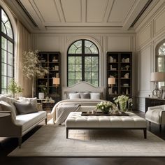 a living room filled with lots of furniture next to large windows on either side of the wall