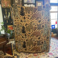 an animal themed area rug on display in a living room with zebras and trees