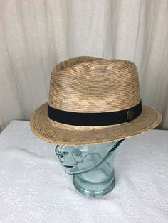 A very nice woven palm fedora by Tula of Mexico.  This is a unisex style hat in a natural color palm.  It is tightly woven and looks as if new.  It has a black ribbon hat band and a Tula pin.  The size is not listed but it is a expandable sweatband allowing for the hat to fit a size medium to an extra large.  It is an extremely attractive hat for either a man or a woman. Casual Woven Straw Hat With Short Brim, Casual Woven Hat With Short Brim, Casual Woven Brimmed Panama Hat, Casual Woven Brimmed Hat, Adjustable Flat Bill Hat For Beach, Adjustable Fit Flat Bill Hat For Beach, Adjustable Flat Bill Beach Hat, Adjustable Fit Flat Bill Summer Hats, Adjustable Woven Fedora For Kentucky Derby