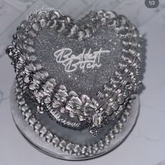 a heart shaped cake with writing on it