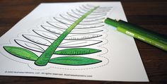 a green pencil sitting on top of a piece of paper with a drawing of a fern