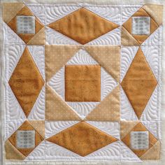 an orange and white quilt with squares on it