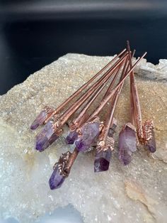 "Dainty Raw Amethyst Crystal Hair Sticks are back by POPULAR demand and with more purchase options! Need some good vibes whispering in your ear, these February Birthstones can remind that Crown Chakra to stay focused and keep the PEACE 💜   ✨ Approximately 4\" Tall and .25\" Wide Set of Two= 2 hair sticks Set of Three=3 hair sticks Set of Four=4 hair sticks Set of Five= 5 hair sticks  ⭐️ Please note the sizing (pic with ruler) prior to your purchase. The pictures are macro photography and appear larger in photos. These pins are meant to accent your hairstyle and NOT to hold up hair.  Need something thicker? Check these out!  https://www.etsy.com/BinkStudio/listing/1283948217/raw-crystal-hair-stick-ready-to-ship?utm_source=Copy&utm_medium=ListingManager&utm_campaign=Share&utm_term=so.lmsm&s Amethyst Hair, Raw Amethyst Crystal, Whisper In Your Ear, Keep The Peace, Hippy Gifts, Raw Amethyst, Hair Accessories Gift, Wedding Boho, Copper Tubing