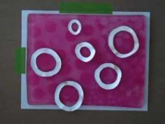 some white circles on a pink and green background