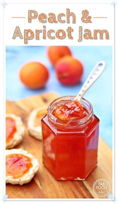 a wooden cutting board topped with jam next to small oranges and other food items