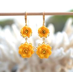 Featuring a pair of double Yellow Roses with Yellow Swarovski Crystal in the center. Color Options: - Golden Yellow. - Sunshine-Golden Yellow Details: Rose Flower size is approximately 13-14mm (smaller) and Approx 18-19mm (larger). Glued on Filigrees. The entire length from top to bottom is approximately 50mm. Gold plated lever back (pictured). Antiqued brass and silver plated Earwires available. Yellow Swarovski Crystals (pictured). Clear Crystal available. Drop a note if you prefer clear cryst Yellow Flower Jewellery, Baking Polymer Clay, Yellow Crystals, Yellow Sunshine, Sunshine Yellow, Matching Jewelry, Nature Inspired Jewelry, Floral Jewellery, All Flowers