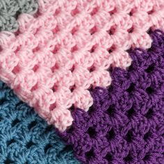 three crocheted blankets are stacked on top of each other, one is blue and the other is pink