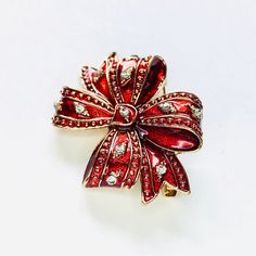 Red rhinestone Christmas bow holiday brooch! Not intended for children ages 13 and under. Also, for many items we can accommodate large orders, so please send us a message. Holiday Rhinestone Jewelry For Gifts, Holiday Rhinestone Jewelry Gift, Holiday Gift Jewelry With Rhinestones, Holiday Jewelry Gift With Rhinestones, Christmas Gift Rhinestone Jewelry, Red Brooch For Valentine's Day Party, Rhinestone Jewelry Christmas Gift, Christmas Gift Jewelry With Rhinestones, Christmas Brooch Jewelry Gift