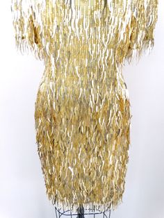 "This is a dazzling vintage piece! It's fully embellished with fringed gold glass beading and cat tail sequins all over! It's in perfect condition! Measurements: Bust - 36\" Waist - 28\" Hips - 38\" Dress Length - 36\" Tag Size - 6 All of my items come from a smoke-free and pet-free home. If you would like more info or have any questions, please don't hesitate to ask!" Gold Sequin Cocktail Evening Dress, Gold Sequined Evening Dress For Cocktail, Vintage Gold Flapper Dress For Party, Gold Fringe Dress For Party Season, Gold Embellished Fitted Flapper Dress, Gold Rhinestone Fringe Evening Dress, Glamorous Gold Flapper Dress For Evening, Glamorous Gold Flapper Dress For Cocktail, Gold Evening Dress With Rhinestone Fringe