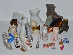 These miniature shoes are from a large estate lot, the person collected all kinds of tiny shoes, shoe figurines, shoe ornaments, shoe souvenirs, Barbie shoes, pincushions, magnets, ashtrays etc. etc.  I am listing this huge collection as  lots, I simply have too many to research and list them individually. Sorry I will not break up these lots as they are already packaged to ship in large priority boxes. Due to the sheer size of this estate collection I will not be measuring individual items, pulling out just one to sell etc these being sold as lots :) See photos for description and condition.  All from 1990s or older, some much older.  Free shipping is included. Keep browsing my shop for other fun finds! https://fabulousvintagestore.etsy.com Tiny Purses, Miniature Shoes, Fragile Label, Shoe Ornaments, Glass Shoes, Barbie Shoes, Ashtrays, Glass Birds, Vintage Store