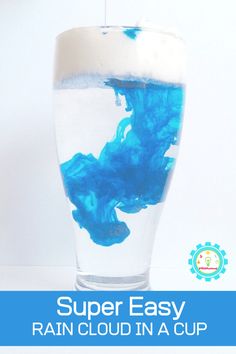 a glass filled with blue liquid and the words super easy rain cloud in a cup