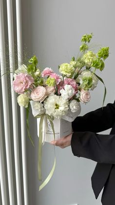 a woman is holding a bouquet of flowers