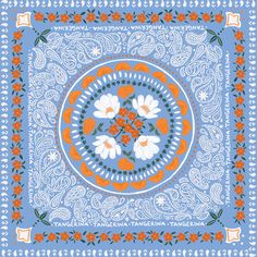 an orange and white flowered bandanna on a blue background with paisley designs in the center