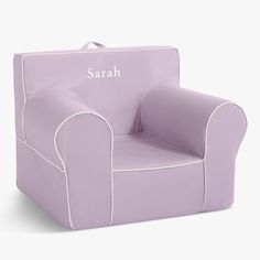 a little kid's purple chair with the name sarah on it and white piping