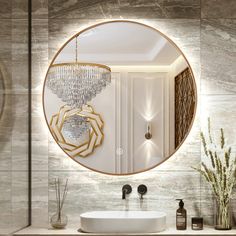 a bathroom with a round mirror above the sink and a chandelier hanging from the ceiling