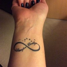 a woman's wrist with a tattoo on it