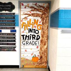 a classroom door decorated with fall themed writing and an orange pumpkin sitting on the floor