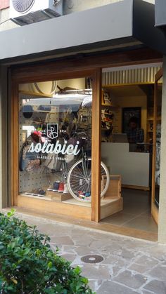 a store front with a bicycle in the window