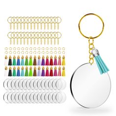 a round keychain with various colored tassels on it and two circular mirrors