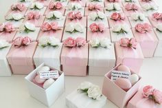 several pink and white boxes with flowers on them