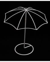 an umbrella is lit up in the dark with its light shining on it's base