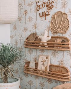 two wicker shelves on the wall in a room with palm trees and other decorations