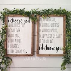 two wooden framed signs hanging on the side of a wall with ivy growing over them