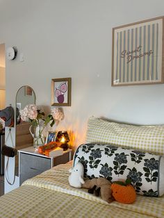 a bed room with two beds and a stuffed animal on top of the bed in front of a mirror