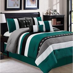 a bed with green and white comforters in a room