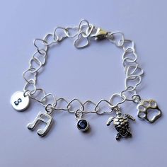 Personalized charm bracelet + Sterling silver heart (5.3 mm) bracelet with lobster clasp (can be adjusted upto 7 inch) + Sterling silver disk (9mm) + Sterling silver music note (10mm) + Sterling silver birthstone (5mm) + Sterling silver turtle charm (10mm) + Sterling silver paw print (8mm) * Every item comes in a pretty gift box * I can also make it with other charms in my shop, please contact me if you would like different designs Adjustable Charm Bracelet With Lobster Clasp For Birthday, Adjustable Nickel-free Charm Bracelet For Birthday Gift, Adjustable Nickel-free Charm Bracelet For Birthday, Adjustable Sterling Silver Charm Bracelet For Birthday, Adjustable Sterling Silver Charm Bracelet For Birthday Gift, Music-themed Silver Bracelet As A Gift, Personalized Adjustable Dangle Charm Bracelet, Silver Music-themed Bracelets For Gifts, Silver Music-themed Bracelet As Gift