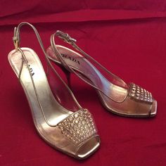 "clear plastic vinyl with gold leather trim by Prada made in Italy Gently worn, loss of gold color on trim and heel edge, metal spike heel with amber resin heel accent. All rhinestones are there, no damage , only marks and signs of normal wear. 9 7/8\" insole 3\" heel 3 \"sole width Leather sole" Chic Gold Heels With Metal Feet, Formal Patent Leather Heels With Rhinestones, Gold Closed Toe Heels With Metal Feet, Champagne Heels With Rhinestones For Formal Occasions, Gold Embellished Heels For Party, Formal Champagne Heels With Rhinestones, Luxury High Heels With Metallic Accents, Gold Heels With Rhinestones, Open Heel Style, Classic Gold Heels For Gala