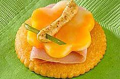 ham and cheese sandwich on crackers with green napkin in the backgroung