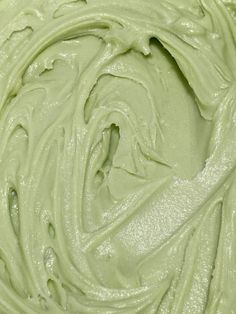 a close up view of the inside of a green frosted cake with icing