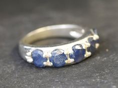 a silver ring with blue stones on it