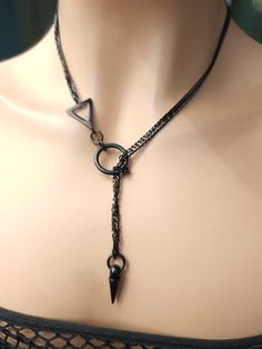 This is a bold and edgy blackened steel Lariat Goth Grunge Alt aesthetic Necklacevwrap choker with Spike pendant.  The minimalist design gives it a trendy and stylish feel, while the black steel gives it a touch of gothic Punk edge. This necklace is versatile, and can be worn long or doubled up for a layered look depending on what size you choose. Goth Jewelry Necklaces, Unique Jewelry Necklaces, Ring On Necklace Chain, Black Jewelry Aesthetic, Goth Jewelry Aesthetic, Goth Accessories Jewellery, Goth Jewelry Diy, Chokers Aesthetic, Grunge Alt Aesthetic