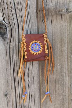 A beaded amulet bag made in rust colored leather with saddle lace. This small beaded pouch measures approximately 4 inches tall x 3 inches wide and has a braided neck strap that measures 28 inches. This is a very beautiful necklace bag where you can keep something very special close to your heart. Props are not included. This item is MADE TO ORDER. You will not receive the piece you see in the photos, we will make one similar for you. Please allow 3 to 4 weeks to ship and take the time to read o Beaded Brown Shoulder Bag Gift, Handmade Brown Shoulder Bag For Festivals, Bohemian Beaded Shoulder Bag For Gift, Artisan Brown Beaded Bag, Bohemian Hand-stitched Shoulder Bag As Gift, Handmade Spiritual Bag For Festivals, Bohemian Brown Beaded Shoulder Bag, Brown Bohemian Bag For Personal Use, Bohemian Brown Bag For Personal Use