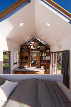 the interior of a tiny home with an open floor plan and skylights above it