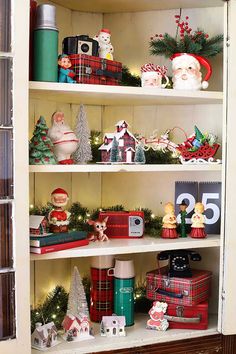 a shelf filled with lots of christmas decorations and presents on top of it's shelves