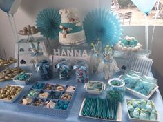 a table topped with blue and white desserts