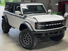 a white truck parked inside of a garage