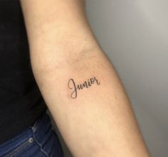 a woman's arm with the word junior written in cursive font on it