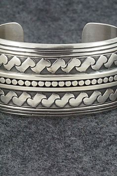 This stunning sterling silver bracelet was made by Navajo silversmith Raymond Delgarito. The back is signed RD and stamped sterling.Size: 5 1/4" (will fit up to a 6 1/4" wrist)Gap: 1"Width: 1 1/4"Free shipping on all orders! We ship with USPS and always include tracking. All orders ship within a day of payment.Returns are accepted up to 30 days after you receive your order. Just send us a message. Our shop offers cash back or store credit. The item must be returned in new condition. Adjustable Silver Southwestern Bangle, Southwestern Silver Bangle Jewelry, Adjustable Southwestern Silver Bangle, Bohemian Sterling Silver Bracelet Stamped 925, Southwestern Style Silver Round Cuff Bracelet, Bohemian Antique Silver Sterling Silver Bracelet, Bohemian Antique Sterling Silver Bracelet, Bohemian Sterling Silver Bangle Stamped 925, Southwestern Silver Bracelet With Oxidized Finish