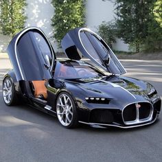 a black bugatti is parked in front of a building with its doors open